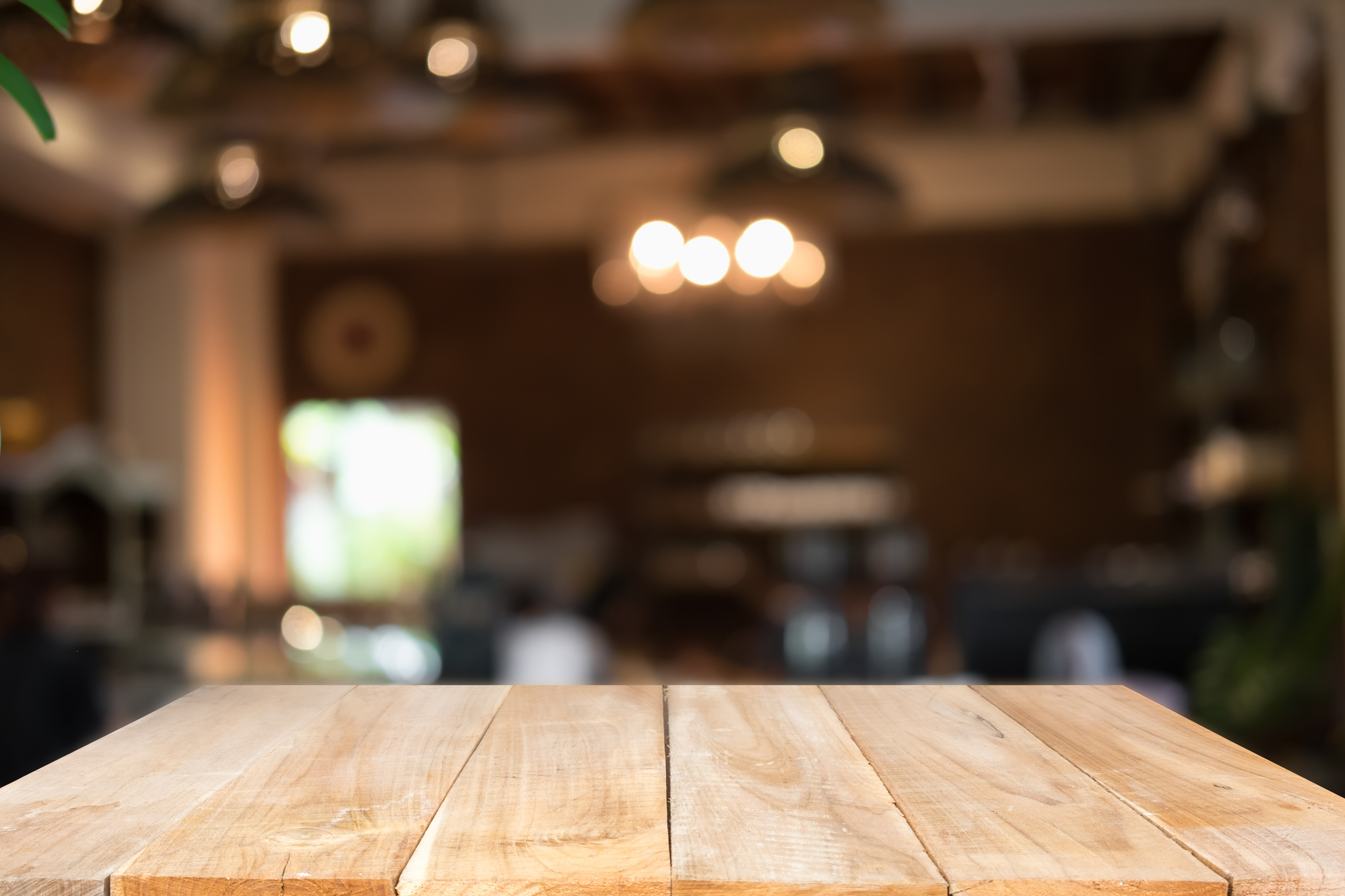 Empty Wooden Table on Blurred Restaurant Background